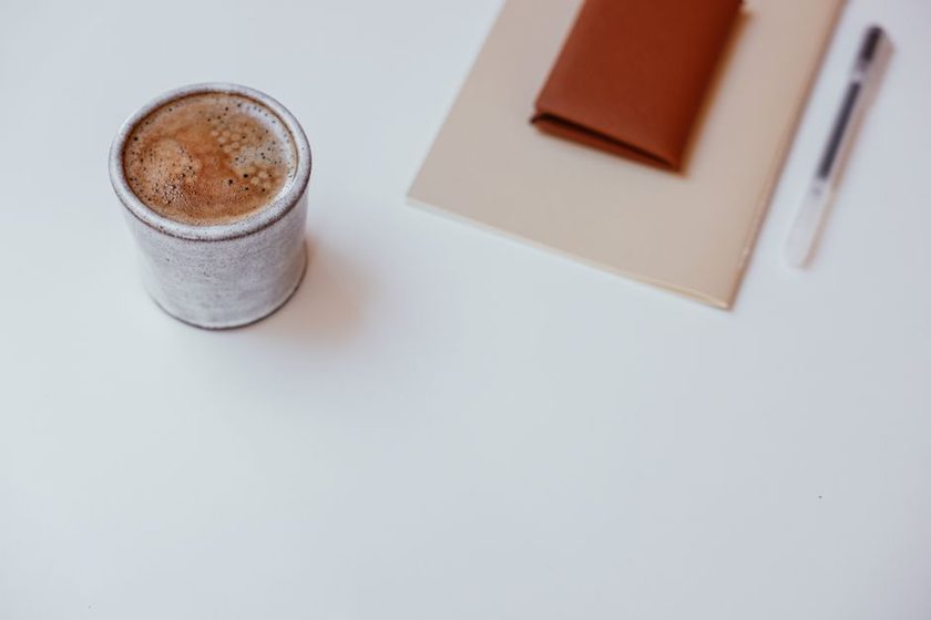 A cup of coffee on a kitchen counter in soft morning light